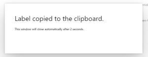 A D365FO dialog form showing the message "Label copied to clipboard"